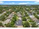 An aerial view showcases a neighborhood filled with mature trees, lush landscaping, and access to nearby lakes at 1640 Mayfield Ave, Winter Park, FL 32789
