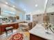 Bright bathroom featuring double vanities, jacuzzi tub, tiled walk-in shower, and tile floors at 1640 Mayfield Ave, Winter Park, FL 32789