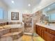 Bathroom with jacuzzi tub, walk-in shower, vanity, and tile floor, offering a relaxing retreat at 1640 Mayfield Ave, Winter Park, FL 32789