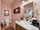 Charming powder room features flamingo wallpaper, a decorative mirror, and elegant fixtures at 1640 Mayfield Ave, Winter Park, FL 32789