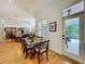 Dining area adjacent to the living room features a glass table and access to the outdoor patio and pool area at 1640 Mayfield Ave, Winter Park, FL 32789