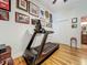 Workout room highlighting a modern treadmill and motivational wall decor for fitness enthusiasts at 1640 Mayfield Ave, Winter Park, FL 32789