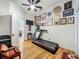 Home gym featuring a sleek treadmill, motivational decor, and a hardwood floor at 1640 Mayfield Ave, Winter Park, FL 32789