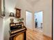 Hallway featuring a vintage secretary desk and wall clock with an entrance to a laundry room at 1640 Mayfield Ave, Winter Park, FL 32789