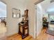 Hallway showing decorative desk, mirror, and doorway leading to a living area with hardwood flooring throughout at 1640 Mayfield Ave, Winter Park, FL 32789