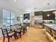 An open layout kitchen and dining area features stainless appliances, wine storage, and access to the outdoor patio at 1640 Mayfield Ave, Winter Park, FL 32789