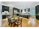 Spacious kitchen with dark wood cabinets and stainless appliances opens to a dining area with access to the pool at 1640 Mayfield Ave, Winter Park, FL 32789