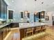 Modern kitchen features dark cabinets, stainless hood, large island with countertop seating, and warm pendant lighting at 1640 Mayfield Ave, Winter Park, FL 32789
