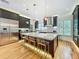 Modern kitchen with a large island, stainless steel appliances, custom cabinetry, and stylish lighting at 1640 Mayfield Ave, Winter Park, FL 32789