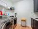 This laundry room features tile floors, LG washer/dryer, overhead shelf, and dark cabinets and backsplash over the sink at 1640 Mayfield Ave, Winter Park, FL 32789
