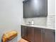 Laundry room featuring updated cabinetry, marble backsplash, sink, and marble countertops at 1640 Mayfield Ave, Winter Park, FL 32789