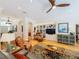 Bright and airy living room with hardwood floors, built-in shelving, and comfortable seating areas, adjacent to bathroom at 1640 Mayfield Ave, Winter Park, FL 32789
