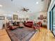 Spacious living room featuring hardwood floors, a ceiling fan, and multiple seating arrangements at 1640 Mayfield Ave, Winter Park, FL 32789