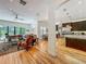 Open layout connecting the living room and kitchen, with hardwood floors and modern design elements at 1640 Mayfield Ave, Winter Park, FL 32789