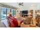 Inviting living room with backyard access, hardwood floors, and a modern entertainment setup at 1640 Mayfield Ave, Winter Park, FL 32789