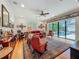Living room with hardwood floors and seating area with backyard views to pool, with interior artwork on walls at 1640 Mayfield Ave, Winter Park, FL 32789