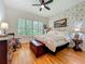 This main bedroom showcases hardwood floors, a white metal bed frame, shuttered windows, and butterfly-themed wallpaper at 1640 Mayfield Ave, Winter Park, FL 32789