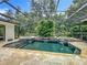 Screened in pool featuring waterfalls and mature landscaping at 1640 Mayfield Ave, Winter Park, FL 32789