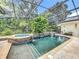 Beautiful screened-in pool and spa area surrounded by lush landscaping, creating a private outdoor oasis at 1640 Mayfield Ave, Winter Park, FL 32789