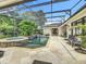 Lovely screened-in pool and patio area with chairs creating a comfortable outdoor living space at 1640 Mayfield Ave, Winter Park, FL 32789