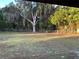 Large backyard featuring mature trees, a chain-link fence, and plenty of space for outdoor activities at 17836 Palm St, Umatilla, FL 32784