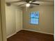 Comfortable bedroom with wood floors, natural light, and a ceiling fan at 17836 Palm St, Umatilla, FL 32784