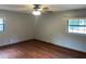 Cozy bedroom with natural light from two windows and a ceiling fan for optimal comfort at 17836 Palm St, Umatilla, FL 32784