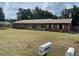 Charming single-story home with a brick exterior, lawn, and inviting curb appeal at 17836 Palm St, Umatilla, FL 32784
