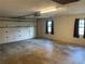 Large garage with natural light from the windows and a standard garage door at 17836 Palm St, Umatilla, FL 32784