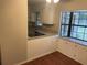 Bright kitchen nook with a bay window and built-in storage cabinets, wood-look flooring and granite counters at 17836 Palm St, Umatilla, FL 32784