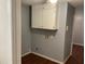 Utility room with overhead storage cabinet and washer/dryer hookups, showcasing practicality at 17836 Palm St, Umatilla, FL 32784