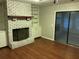 Living room featuring hardwood floors, brick fireplace and built in shelving at 17836 Palm St, Umatilla, FL 32784