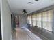 Enclosed sunroom with tile floors, ceiling fan, and lots of natural light at 17836 Palm St, Umatilla, FL 32784