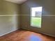 Bedroom with tile floors and a window overlooking a green lawn at 1809 Elm Ridge Ct, Orlando, FL 32808