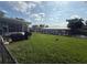 Waterfront backyard with a covered boat lift and green lawn at 1811 Missouri Ave, Sanford, FL 32771