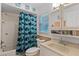 Bright bathroom featuring a vanity, commode, tub, shower, and fun shark-themed shower curtain at 1811 Missouri Ave, Sanford, FL 32771