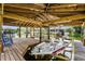 A boat lift with a boat resting on it, alongside a wooden dock with blue rocking chairs at 1811 Missouri Ave, Sanford, FL 32771