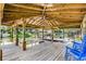 Covered boat dock with wooden beams, a boat lift, and ample space for seating at 1811 Missouri Ave, Sanford, FL 32771