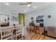 Bright dining area with hardwood floors, a ceiling fan, and a breakfast bar with seating at 1811 Missouri Ave, Sanford, FL 32771