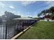 Scenic view of a covered boat dock on the water with a grassy shoreline at 1811 Missouri Ave, Sanford, FL 32771