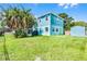 View of the exterior of the home showing the lush yard, shed, and blue siding at 1811 Missouri Ave, Sanford, FL 32771