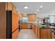 Bright kitchen with tile floors, wood cabinets, and granite countertops at 1811 Missouri Ave, Sanford, FL 32771