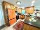 Bright kitchen featuring wooden cabinetry, a granite countertop, and tiled floors at 1811 Missouri Ave, Sanford, FL 32771