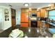 Bright kitchen featuring wood cabinetry, granite countertops, and an island at 1811 Missouri Ave, Sanford, FL 32771