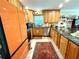 Well-lit kitchen with granite counters, wooden cabinets, and stainless steel appliances at 1811 Missouri Ave, Sanford, FL 32771