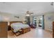 Spacious main bedroom with wood floors, ceiling fan, and private access to patio at 1811 Missouri Ave, Sanford, FL 32771