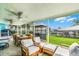 Screened outdoor patio with dining and living furniture overlooking the backyard and canal at 1811 Missouri Ave, Sanford, FL 32771