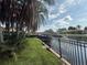 Waterfront property featuring lush greenery and a dock with a covered boat lift at 1811 Missouri Ave, Sanford, FL 32771