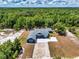 Stunning aerial view of a single-story home surrounded by lush greenery and trees at 1845 Springhead Dr, Deltona, FL 32725