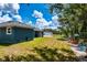 Large backyard features green grass, playground, and wooded area at 1845 Springhead Dr, Deltona, FL 32725